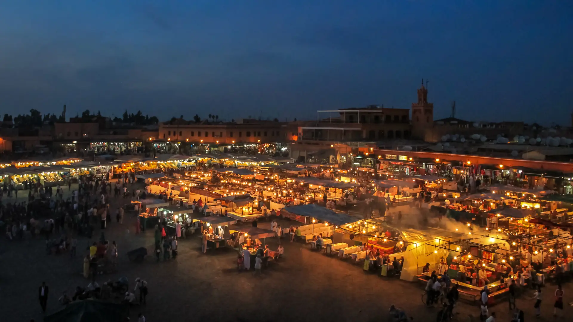 Jemaa el-Fna square at night with food stalls lit up, Marrakech, Morocco 