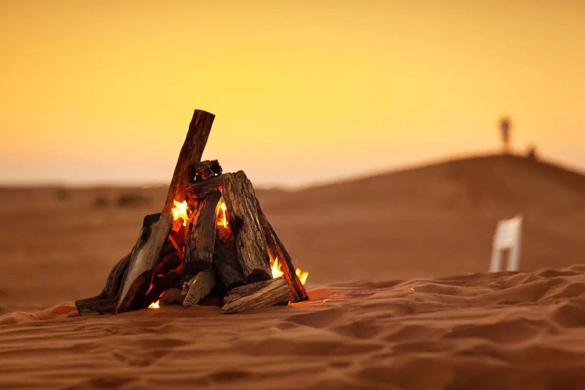 Campfire at sunset in a Sahara desert camp, Morocco